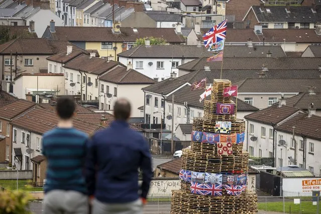 People view a bonfire stack prior to it being lit to mark the Catholic Feast of the Assumption in the Bogside area of Londonderry, Northern Ireland on Monday, August 15, 2022. (Photo by Liam McBurney/PA Images via Getty Images)