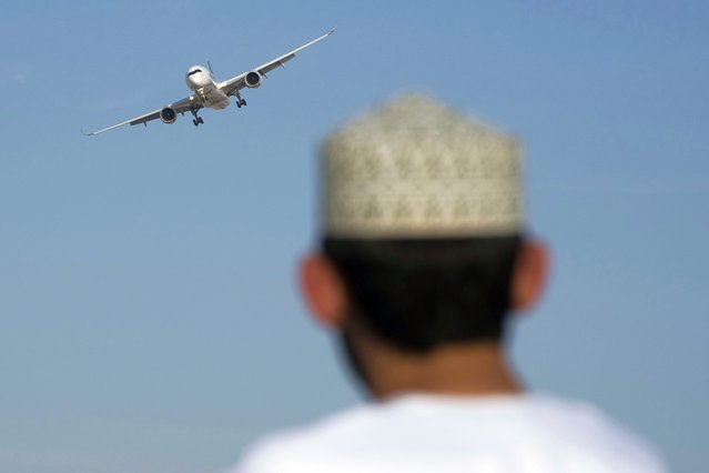 A man watches an Airbus A350 at the Dubai Air Show in Dubai, United Arab Emirates, Monday, November 13, 2023. Long-haul carrier Emirates opened the Dubai Air Show with a $52 billion purchase of Boeing Co. aircraft, showing how aviation has bounced back after the groundings of the coronavirus pandemic, even as Israel's war with Hamas clouds regional security. (Photo by Jon Gambrell/AP Photo)