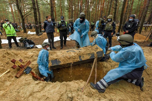 Workers exhume bodies from graves in Izyum, Kharkiv region, northeastern Ukraine, 16 September 2022. A mass burial site was found after Ukrainian troops recaptured the town of Izyum. According to the head of the investigative department of the police of the Kharkiv region, the burial site, one of the largest in a recaptured city so far, counts more than 440 separate graves. The Ukrainian army pushed Russian troops from occupied territory in the northeast of the country in a counterattack. Kharkiv and surrounding areas have been the target of heavy shelling since February 2022, when Russian troops entered Ukraine starting a conflict that has provoked destruction and a humanitarian crisis. (Photo by Oleg Petrasyuk/EPA/EFE)