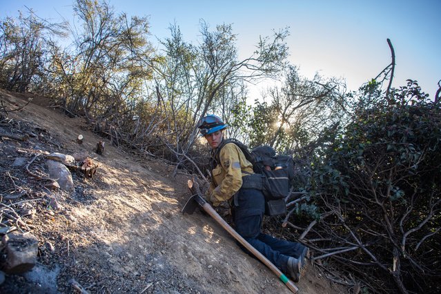 Firefighters work to create a containment fire line to control the Hughes Fire in Castaic, a neighborhood of Los Angeles, California, on January 23, 2025. Firefighters who battled through the night to tame a new blaze that erupted near Los Angeles appeared to be making progress on January 23, even as dangerous fire weather continued throughout Southern California. A massive response involving aircraft, bulldozers and 4,000 personnel had swung into action as flames raced across hillsides in Castaic, 35 miles (56 km) north of Los Angeles. (Photo by Apu Gomes/AFP Photo)