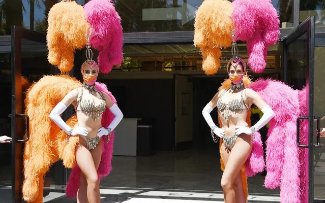 Two showgirls pose for a photo at the reopening of Flamingo Las Vegas on June 4, 2020 in Las Vegas, Nevada. Hotel-casinos throughout the state are opening today as part of a phased reopening of the economy with social distancing guidelines and other restrictions in place due to the coronavirus (COVID-19) pandemic. (Photo by Denise Truscello/Getty Images for Caesars Entertainment)