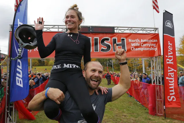 Christina Arsenault and Jesse Wall (R) celebrate after winning the North American Wife Carrying Championship at Sunday River ski resort in Newry, Maine October 11, 2014. REUTERS/Brian Snyder