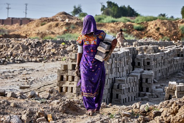 A woman works at a brick kiln during May Day, on the outskirts of Hyderabad, Pakistan, Thursday, May 1, 2025. (Photo by Pervez Masih/AP Photo)