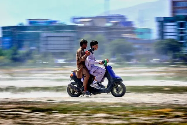 Afghan youths ride a motorcycle during the Muslim festival of Eid al-Adha in Kabul, Afghanistan, 31 July 2020. Eid al-Adha is the holiest of the two Muslims holidays celebrated each year, it marks the yearly Muslim pilgrimage (Hajj) to visit Mecca, the holiest place in Islam. Muslims slaughter a sacrificial animal and split the meat into three parts, one for the family, one for friends and relatives, and one for the poor and needy. (Photo by Hedayatullah Amid/EPA/EFE)