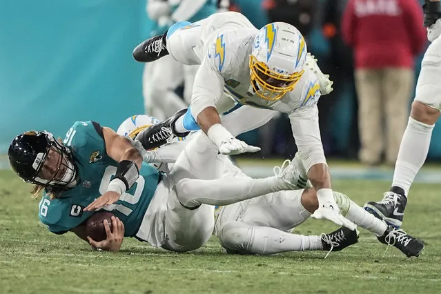 Jacksonville Jaguars quarterback Trevor Lawrence (16) is sacked against the Los Angeles Chargers during the second half of an NFL wild-card football game, Saturday, January 14, 2023, in Jacksonville, Fla. The Los Angeles Chargers were called for a penalty voiding the sack. (Photo by Chris Carlson/AP Photo)