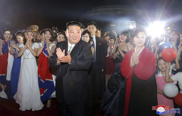 This photo provided by the North Korean government shows North Korean leader Kim Jong Un, front left, and his wife Ri Sol Ju, right, meet performers during a celebration marking the nation's 74th anniversary in Pyongyang, North Korea, on September 8, 2022. (Photo by Korean Central News Agency/Korea News Service via AP Photo)