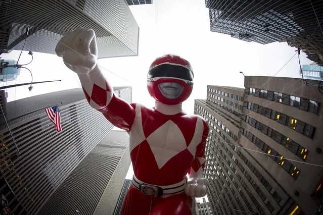 The Red Mighty Morphin Power Ranger balloon floats down Sixth Avenue during the 88th Annual Macy's Thanksgiving Day Parade in New York November 27, 2014. (Photo by Andrew Kelly/Reuters)