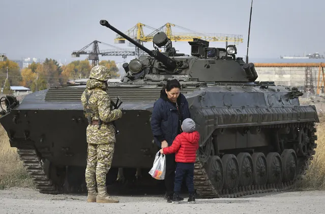 Soldiers of Kyrgyz army stand at checkpoint on city street in Bishkek, Kyrgyzstan, Saturday, October 10, 2020. (Photo by Vladimir Voronin/AP Photo)