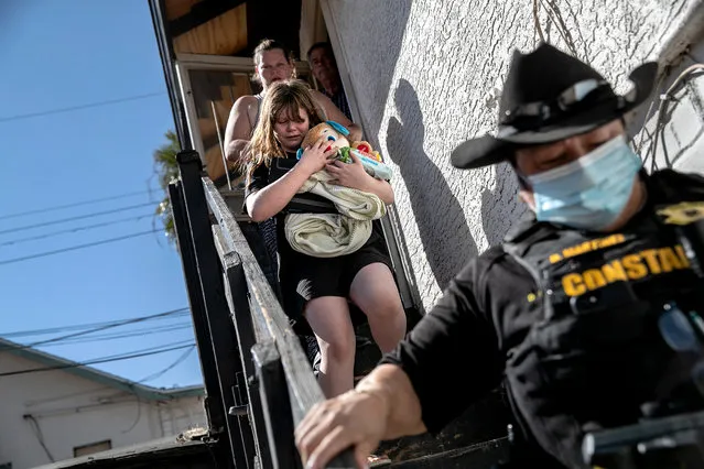 Maricopa County constable Darlene Martinez escorts a family out of their apartment after serving an eviction order for non-payment on September 30, 2020 in Phoenix, Arizona. Thousands of court-ordered evictions continue nationwide despite a Centers for Disease Control (CDC) moratorium for renters impacted by the coronavirus pandemic. Although state and county officials say they have tried to educate the public on the protections, many renters remain unaware and fail to complete the necessary forms to remain in their homes. With millions of Americans still unemployed due to the pandemic and federal rental assistance proposals gridlocked in Congress, the expiry of the CDC moratorium at year's end looms large for renters and landlords alike.  (Photo by John Moore/Getty Images)