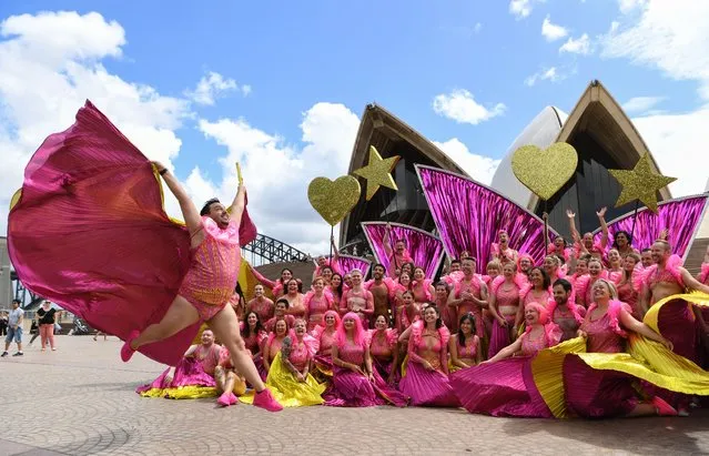 A member of the Mardi Gras parade group jumps in front of other participants at a media call for the Opera House float ahead of the Mardi Gras Parade on February 24, 2023 in Sydney, Australia. A 60-strong group of marching Opera House staff dressed in dazzling costumes will dance through Sydney on the weekend for the Mardi Gras parade alongside a specially designed Opera House float which features a 10-metre replica of the Opera House’s famous sails, and a sustainable glitter cannon. (Photo by James D. Morgan/Getty Images)