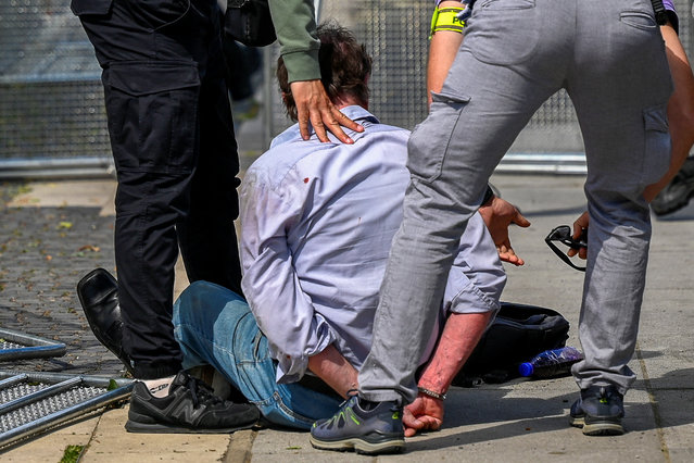 A person is detained after a shooting incident of Slovak PM Robert Fico, after a Slovak government meeting in Handlova, Slovakia, on May 15, 2024. (Photo by Radovan Stoklasa/Reuters)