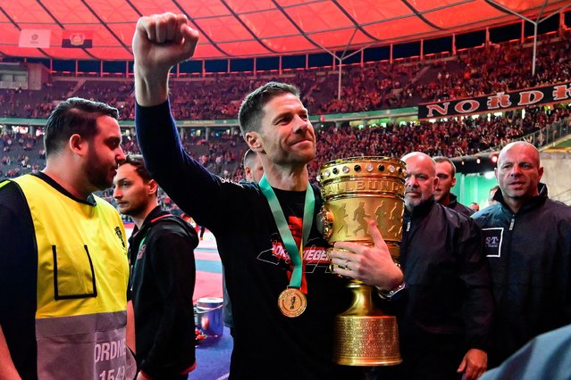 Bayer Leverkusen's Spanish head coach Xabi Alonso celebrates with the trophy after the German Cup (DFB-Pokal) final football match between 1 FC Kaiserslautern and Bayer 04 Leverkusen at the Olympic Stadium in Berlin on May 25, 2024. (Photo by John MacDougall/AFP Photo)