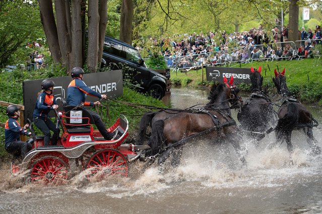 Competitors splash through water in the International Driving Grand Prix at the Royal Windsor Horse Show in the private grounds of Windsor Castle, UK on May 4, 2024. (Photo by Maureen McLean/Rex Features/Shutterstock)