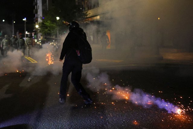 A person reacts as law enforcement officers operate outside the ICE headquarters in Portland, Oregon, U.S., October 4, 2025. (Photo by Carlos Barria/Reuters)