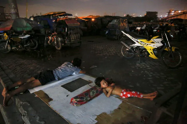 People sleep in open air in Tondo, Manila, Philippines early October 18, 2016. (Photo by Damir Sagolj/Reuters)