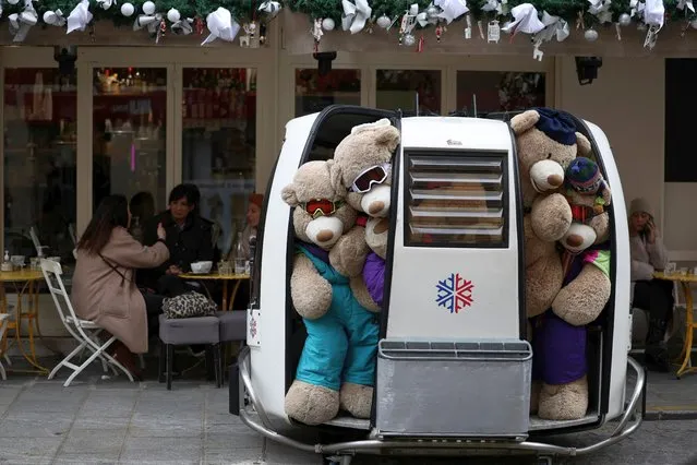 Teddy bears are seen placed in a cable car on the terrace of a cafe in Paris, France, February 4, 2022. (Photo by Sarah Meyssonnier/Reuters)