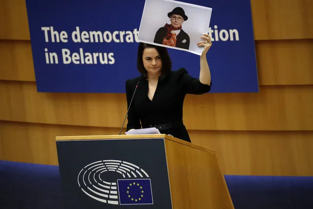 Belarusian opposition politician Sviatlana Tsikhanouskaya holds a picture of Belarusian opposition activist Nina Baginskaya as she gives a speech during the Sakharov Prize ceremony at the European Parliament in Brussels, Wednesday, December 16, 2020. The European Union has awarded its top human rights prize to the Belarusian democratic opposition. (Photo by Francisco Seco/AP Photo)