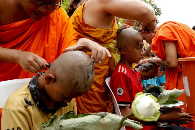 Boys have their hair shaved by monks in preparation for an annual Poy Sang Long celebration, a traditional rite of passage for boys to be initiated as Buddhist novices, in Mae Hong Son, Thailand, April 2, 2018. (Photo by Jorge Silva/Reuters)