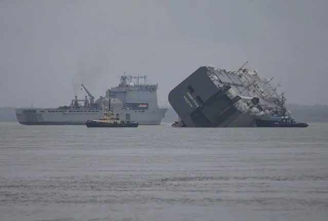The cargo ship Hoegh Osaka lies on its side after being deliberately ran aground on the Bramble Bank in the Solent estuary, near Southampton in southern England January 5, 2015. (Photo by Peter Nicholls/Reuters)