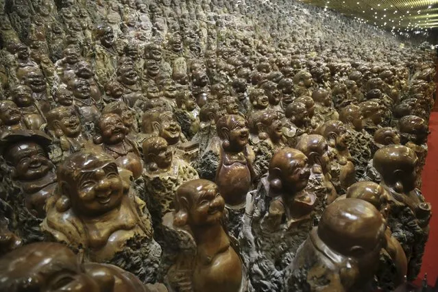 Buddha sculptures made of trunks of Chinese date trees are seen  inside a room of a company selling dates, in Zhengzhou, Henan province, China, November 23, 2015. (Photo by Reuters/Stringer)