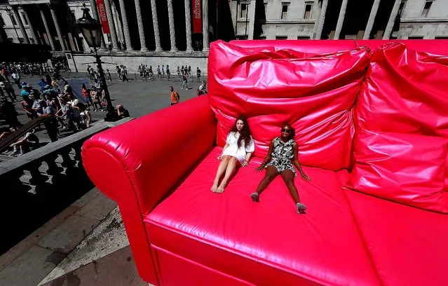 Two girls enjoy the sunshine from a giant pink sofa before the start of the finale of the T-Mobile Big Dance 2010 in Trafalgar Square in London. (Photo by Peter Macdiarmid/Getty Images)