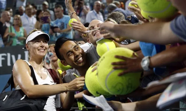 Maria Sharapova of Russia poses for a picture with fans after defeating Elina Svitolina of Ukraine in their women's singles semi final match at the Brisbane International tennis tournament in Brisbane, January 9, 2015. (Photo by Jason Reed/Reuters)