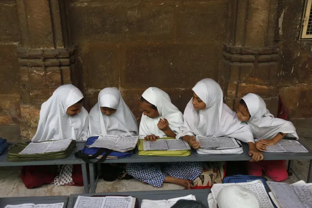 Indian Muslim children learn to read the Quran at Jama Masjid mosque on the first day of the holy Muslim month of Ramadan in Ahmadabad, India, Thursday, May 17, 2018. (Photo by Ajit Solanki/AP Photo)