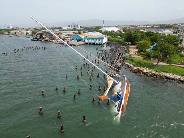 A boat damaged by Hurricane Beryl lays on its side at a dock in Kingston, Jamaica, Thursday, July 4, 2024. (Photo by Leo Hudson/AP Photo)