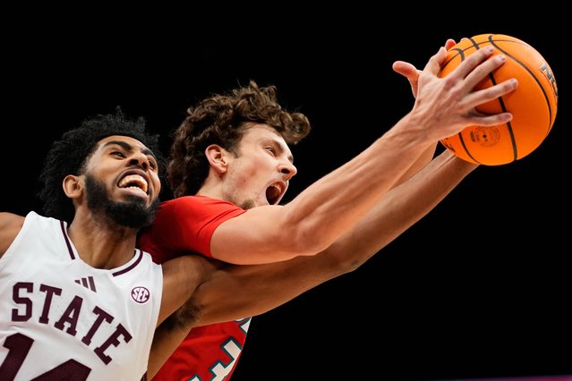 Mississippi State's Amier Ali and New Mexico's Luke Haupt battle for a rebound during an NCAA college basketball game in Kansas City, Mo., November 21, 2025. (Photo by Charlie Riedel/AP Photo)