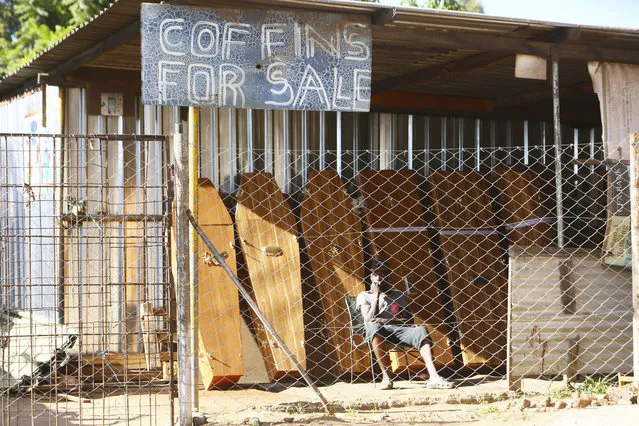 A worker at a coffin making company waits for clients inside the company premises in Harare, Tuesday, January 5, 2021, as Zimbabwe has began a 30-day lockdown in a bid to rein in the spike in COVID -19 infections threatening to overwhelm health services. In response to to rising infections the country has reintroduced a night curfew, banned public gatherings, and indefinitely suspended the opening of schools. (Photo by Tsvangirayi Mukwazhi/AP Photo)