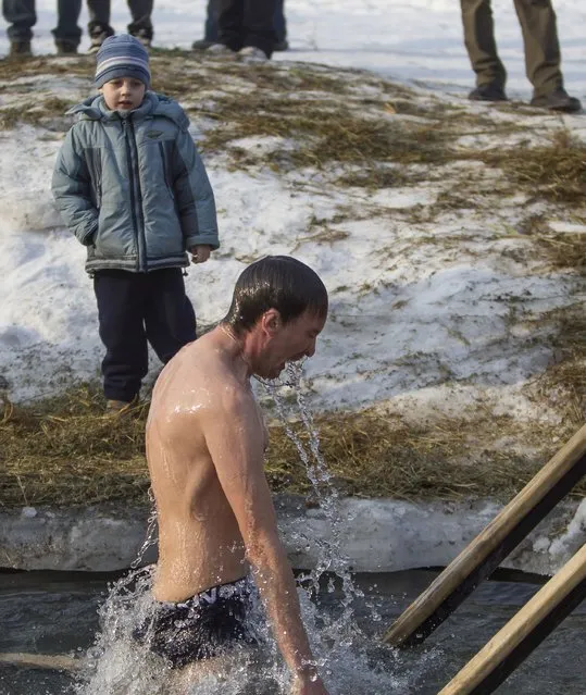 A man bathes in the icy water of the Bolshaya Almatinka river during an Epiphany celebration in Almaty January 19, 2015. (Photo by Shamil Zhumatov/Reuters)