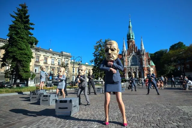 Members of the “Theatre KTO” performing during a new “Peregrinus” street performance at Krakow-Podgorze Market Square in Krakow, Poland on August 12, 2020. (Photo by Cezary Kowalski/SOPA Images/SIPA Press)