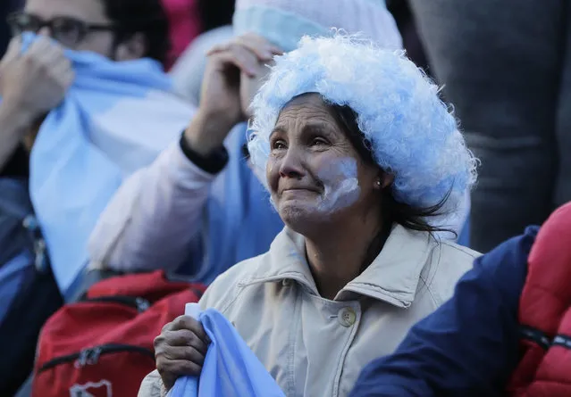 Argentine fans react in disbelief at the end of a televised broadcast of the Croatia vs Argentina World Cup soccer match, in Buenos Aires, Argentina, Thursday, June 21, 2018. Argentina lost 3-0 to Croatia. (Photo by Jorge Saenz/AP Photo)