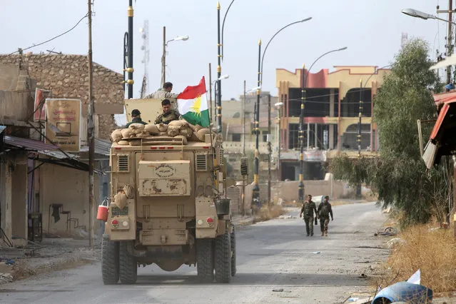 A military vehicle of Peshmerga forces drive in the town of Bashiqa, after it was recaptured from the Islamic State, east of Mosul, Iraq November 10, 2016. (Photo by Alaa Al-Marjani/Reuters)