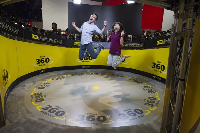 Jacob and Ester Fu jump in the Nikon 360 Degree Project during the 2015 International Consumer Electronics Show (CES) in Las Vegas, Nevada January 6, 2015. The project uses images taken from 48 Nikon D750 cameras to create 360-degree frozen moments and slow motion captures in 5K resolution. (Photo by Steve Marcus/Reuters)
