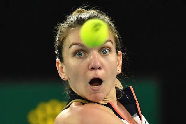 Romania's Simona Halep hits a return against Serena Williams of the US during their women's singles quarter-final match on day nine of the Australian Open tennis tournament in Melbourne on February 16, 2021. (Photo by Paul Crock/AFP Photo)