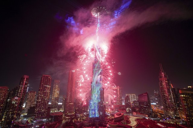 Fireworks explode around the Burj Khalifa during the New Year's celebration in Dubai, United Arab Emirates, Wednesday, January 1, 2025. (Photo by Altaf Qadri/AP Photo)