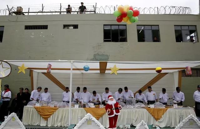 Inmates prepare food during a Christmas event at Sarita Colonia male prison in Callao, Peru, December 18, 2015. (Photo by Mariana Bazo/Reuters)