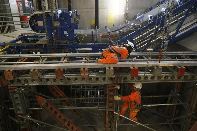 Construction workers install an escalator at the site for the new Crossrail station in Tottenham Court Road, in London, Britain, November 16, 2016. (Photo by Stefan Wermuth/Reuters)