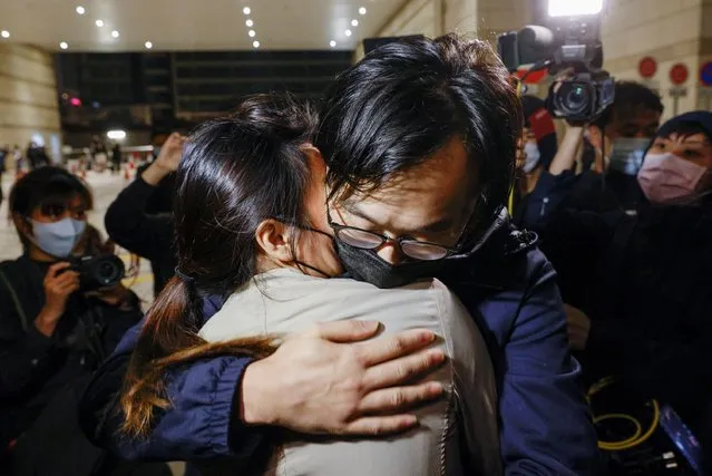 Pro-democracy activist Mike Lam King-Nam embrace his wife as he leave the West Kowloon Magistrates’ Courts on bail over national security law charge with his stepmother, in Hong Kong, China on March 5, 2021. (Photo by Tyrone Siu/Reuters)
