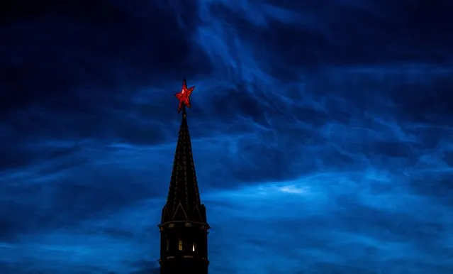 Noctilucent clouds are seen over the tower of Moscow's Kremlin in Russia on July 4, 2023. (Photo by Maxim Shemetov/Reuters)
