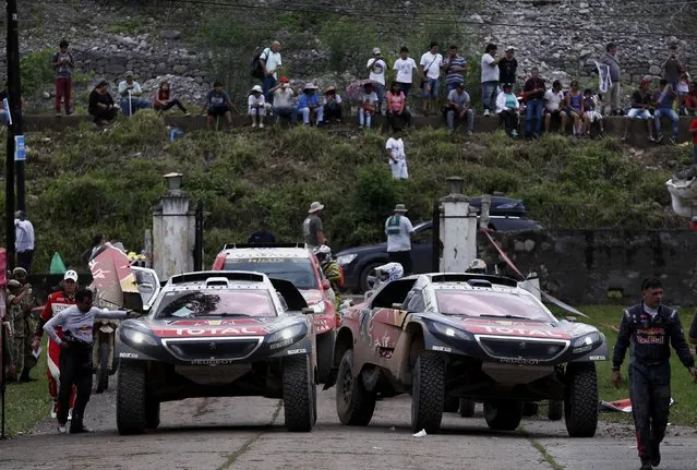 Carlos Sainz of Spain (R) drives his Peugeot past the Peugeot of Sebastien Loeb of France as they arrive at the bivouac at the end of the fourth stage in the Dakar Rally 2016 in Jujuy province, Argentina, January 6, 2016. (Photo by Marcos Brindicci/Reuters)