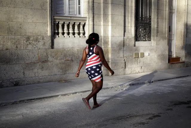 A woman wearing the colors of the U.S. flag walks on a street in Havana July 19, 2015. (Photo by Enrique de la Osa/Reuters)