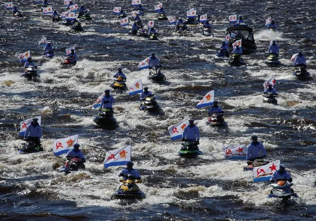 Riders on jet skis take part in the Immortal Fleet event during the celebrations of Victory Day, which marks the 76th anniversary of the victory over Nazi Germany in World War Two, in Saint Petersburg, Russia on May 9, 2021. (Photo by Anton Vaganov/Reuters)