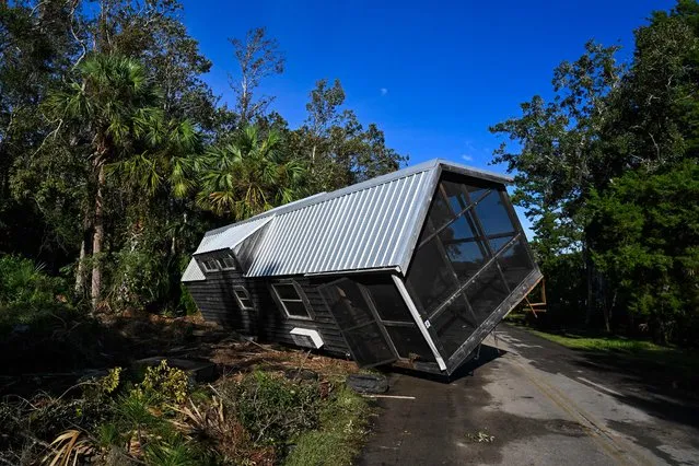 A displaced damaged mobilhome is seen in the middle of a road in Steinhatchee, Florida on August 30, 2023 after Hurricane Idalia made landfall. Idalia slammed into northwest Florida as an "extremely dangerous" Category 3 storm early Wednesday, buffeting coastal communities with cascades of water as officials warned of “catastrophic” flooding in parts of the southern US state. (Photo by Chandan Khanna/AFP Photo)