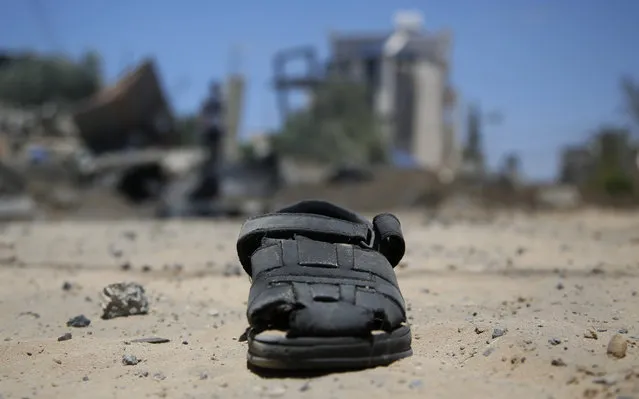 A sandal lies on the ground after a house was hit by early morning Israeli airstrikes in Beit Lahyia, northern Gaza Strip, on Monday, May 17, 2021. The Israeli military unleashed a wave of heavy airstrikes Monday on the Gaza Strip, saying it destroyed 15 kilometers (9 miles) of militant tunnels and the homes of nine Hamas commanders as international diplomats worked to end the weeklong war that has killed hundreds of people. (Photo by Hatem Moussa/AP Photo)
