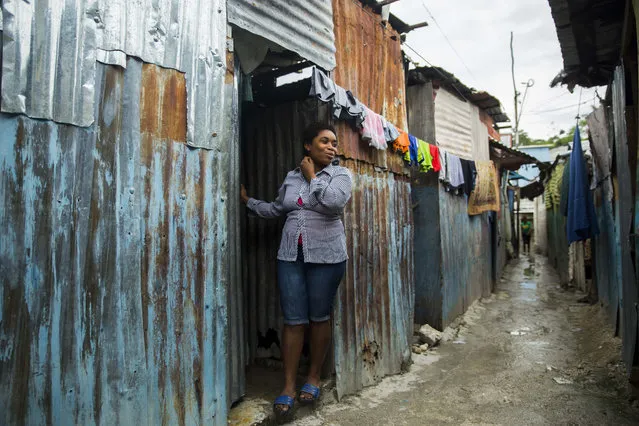 Magdala Louis stands in the doorway of her home in Port-au-Prince, Haiti, Thursday, April 8, 2021. On Dec. 6, 2020, men with automatic weapons kidnapped her and a friend. The two were blindfolded, taken to a house and asked who in their family had money. Eventually, the family of her friend paid for both of their releases, but Louis said she's now too afraid to leave her house to work: “I wish I had died in the (2010) earthquake so as not to have gone through this”. (Photo by Odelyn Joseph/AP Photo)