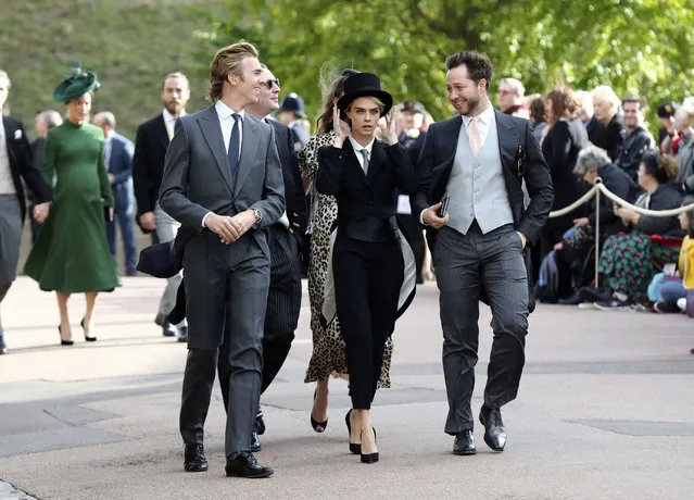 Cara Delevingne, center, arrives ahead of the wedding of Princess Eugenie of York and Jack Brooksbank at St George’s Chapel, Windsor Castle, near London, England, Friday October 12, 2018. (Photo by Gareth Fuller/Pool via AP Photo)