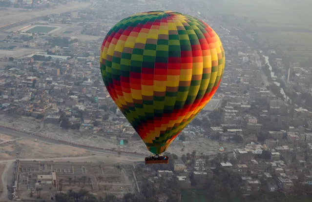 A hot-air balloon flies over the city of Luxor, south of Cairo, Egypt December 13, 2016. (Photo by Amr Abdallah Dalsh/Reuters)