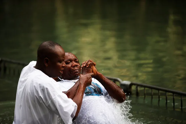 Christian tourists from Nigeria take part in a ceremony at the Yardenit baptismal site, in the Jordan River, which flows out from the Sea of Galilee, northern Israel November 30, 2016. (Photo by Ronen Zvulun/Reuters)